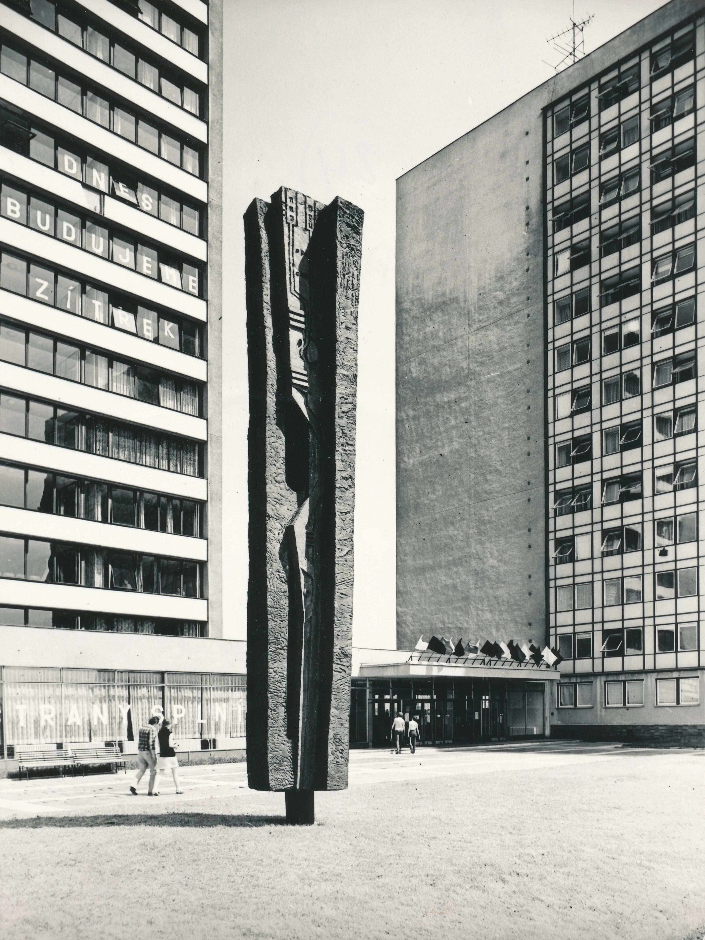 Stela against the background of buildings in its original form, 1973, photoarchive AMO, photo by Petr Sikula